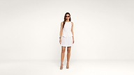 A woman wearing sunglasses, a white sleeveless top, and a white pleated skirt stands facing forward against a plain white background, with her arms relaxed by her sides.