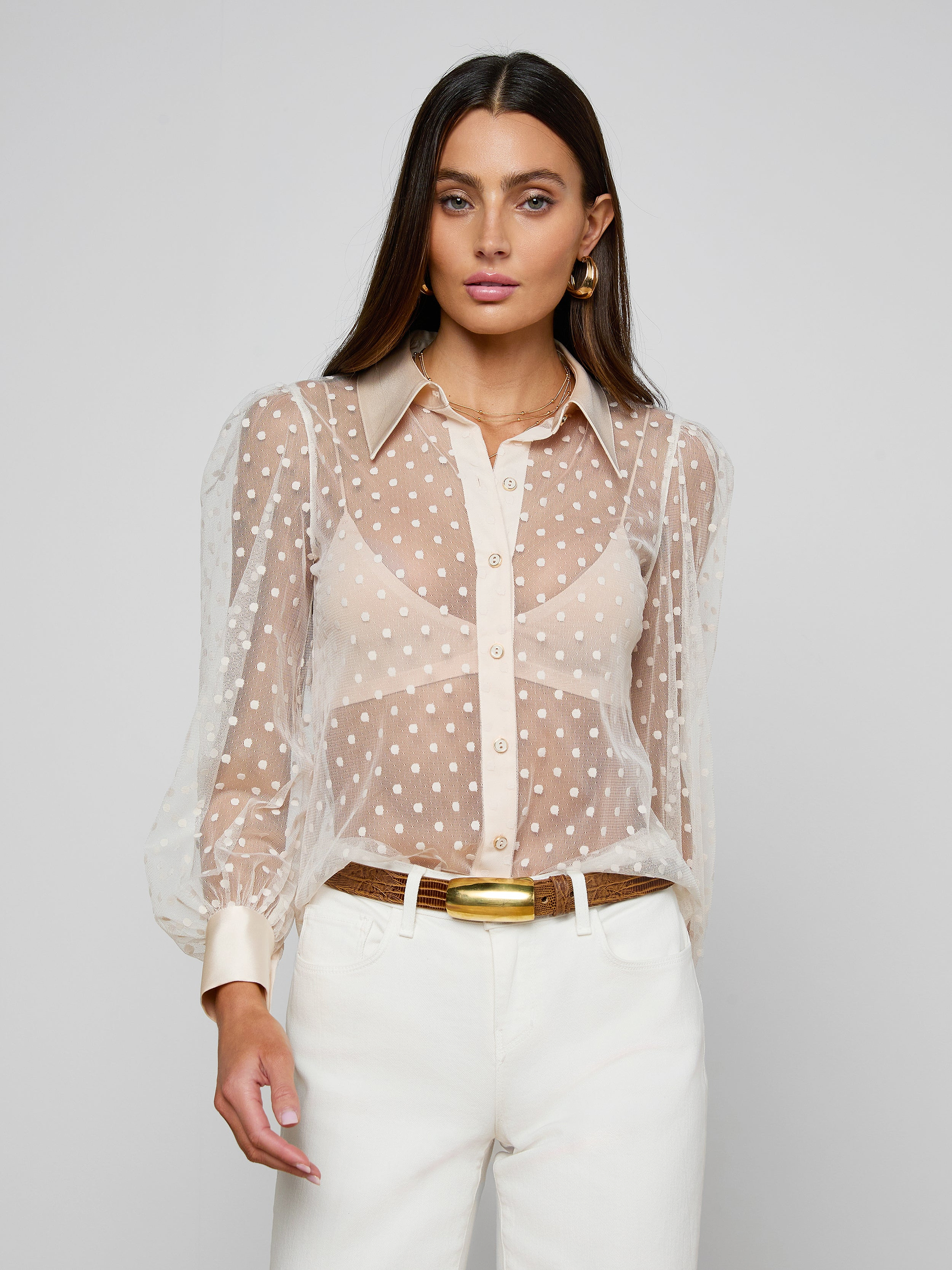 A woman in a sheer Sophie Long-Sleeved Blouse.