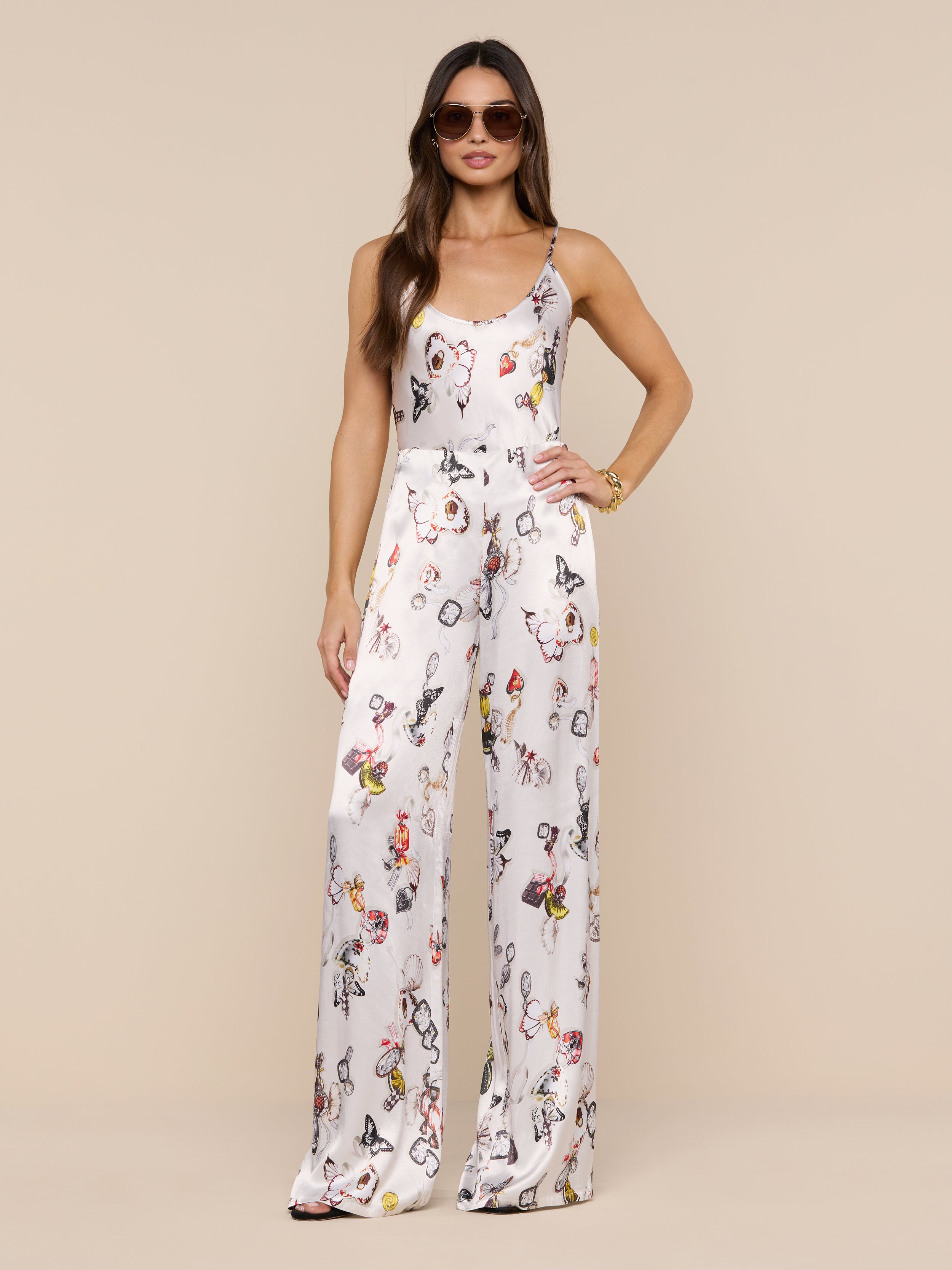 A woman wearing the Charmy Satin Camisole and sunglasses stands confidently against a plain white background.