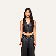 A woman stands facing forward, showcasing the Jianna Leather Vest paired with matching black leather pants and a belt against a plain light background—a look inspired by Fall 2026 fashion.