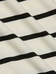 Close-up of the Lucille Striped Boatneck Top, highlighting its ribbed fabric with timeless black and white stripes arranged diagonally to showcase the texture and pattern.