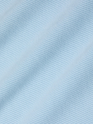 Close-up of the Nica Scoopneck Bodysuit in light blue, featuring fine, diagonal, evenly spaced lines that create a subtle striped pattern. The high recovery stretch rib enhances the soft and smooth texture, giving the fabric a gentle and calming visual effect.