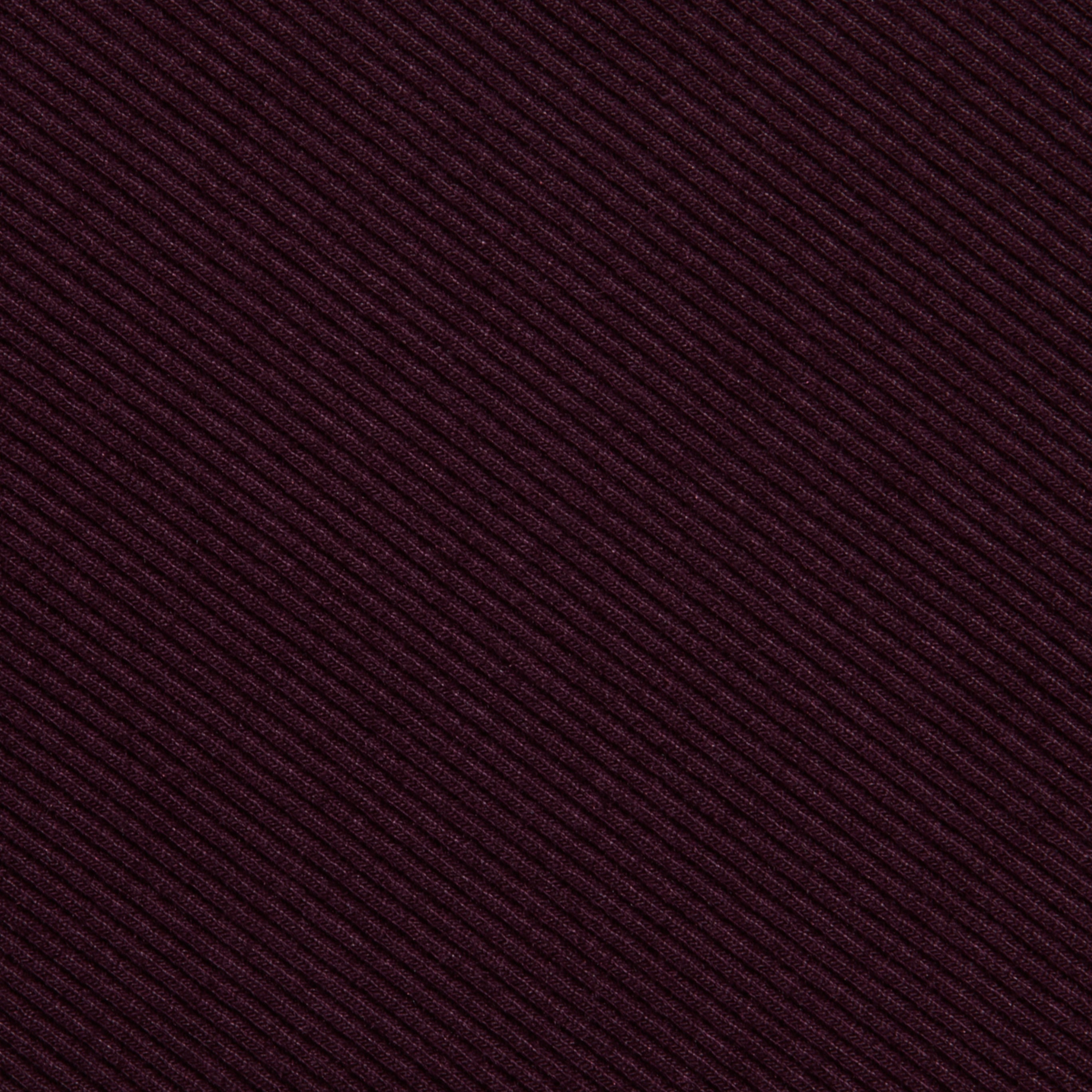 Close-up of the Nica Scoopneck Bodysuit’s textured fabric, showcasing diagonal ribbed lines in a deep burgundy hue and featuring high recovery stretch—perfect for a base layer.