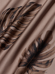 Close-up of the Akiya Satin Maxi Dress in beige, featuring a brown palm leaf print, with soft folds and a smooth, bias-cut satin texture.