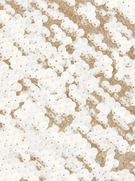 A close-up view of numerous white sequins sewn intricately onto beige fabric, creating a shimmering, textured pattern characteristic of the Karma Sequin Maxi Dress—an ideal statement piece for NYFW 2026.