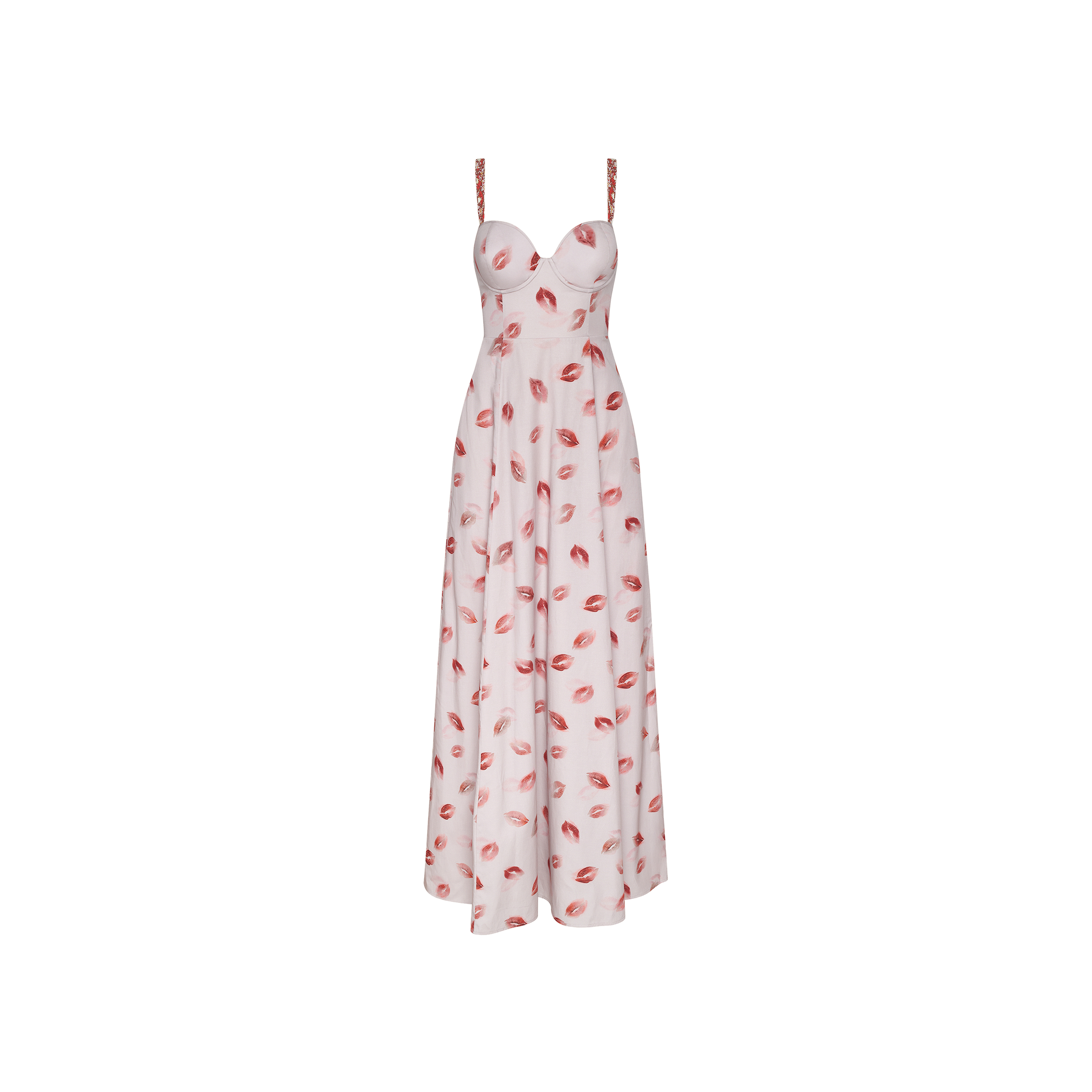 The Sutton Maxi Dress is a sleeveless, white dress adorned with a lipstick-kiss print throughout. It features a sweetheart neckline, thin beaded straps, and a fitted bodice that flares into a flowing skirt.