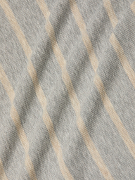 Ellis Tank Dress in gray fabric features beige diagonal stripes, showcasing a soft, textured surface with gentle folds and shadows. The stretch rib pattern adds a subtle, wavy appearance across the material.