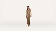 A woman in a sleeveless, gold-sequined floor-length dress stands against a plain white background, looking forward with one hand by her side and the other slightly bent.