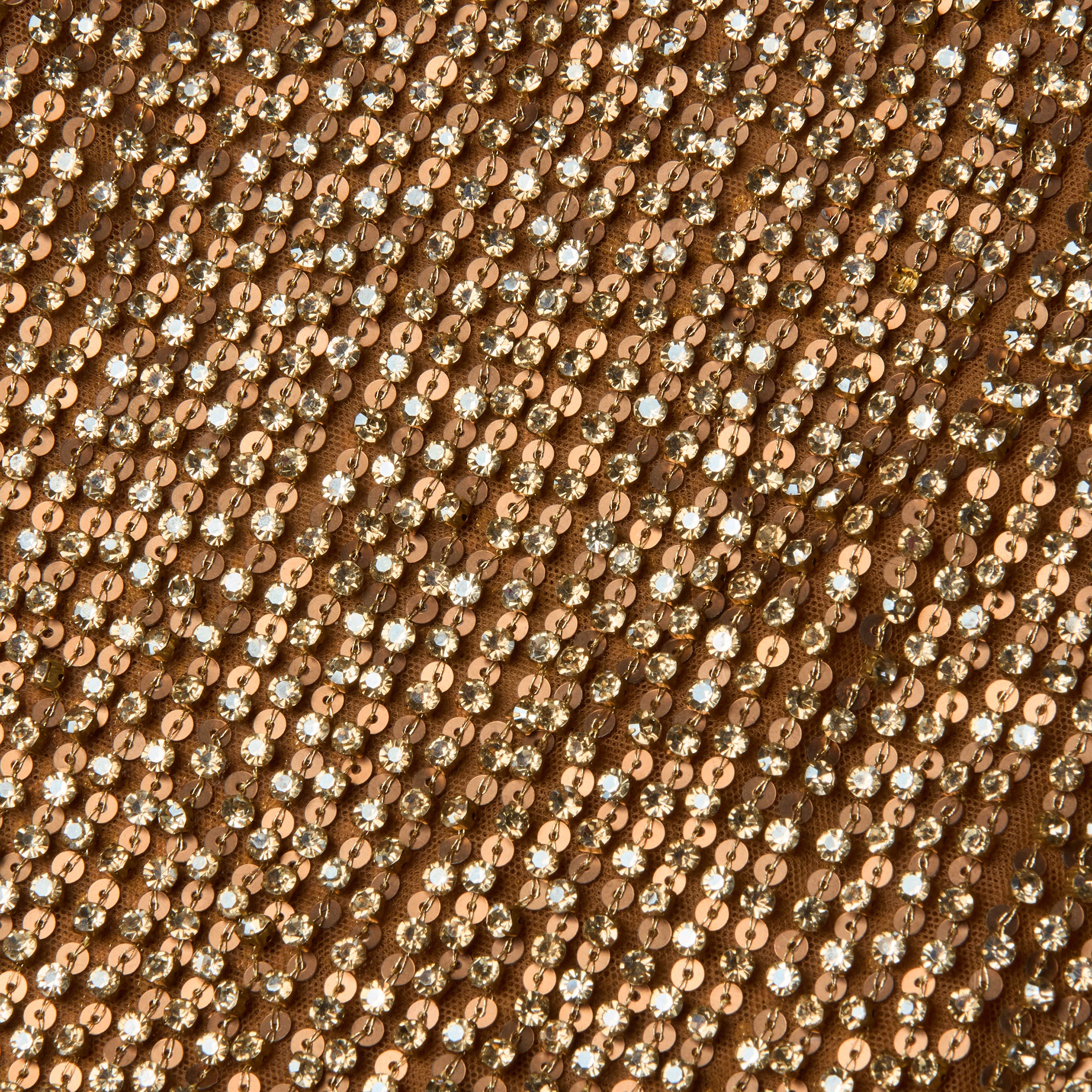 Close-up of the Paula Gown, featuring fabric densely covered in shiny gold sequins that reflect light, creating a sparkling and textured surface reminiscent of a rhinestone-adorned dress.