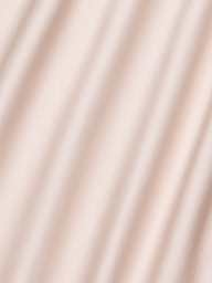 Soft beige fabric with gentle diagonal shadows, creating a subtle wavy texture across the surface—reminiscent of the Akiya Satin Maxi Dress.