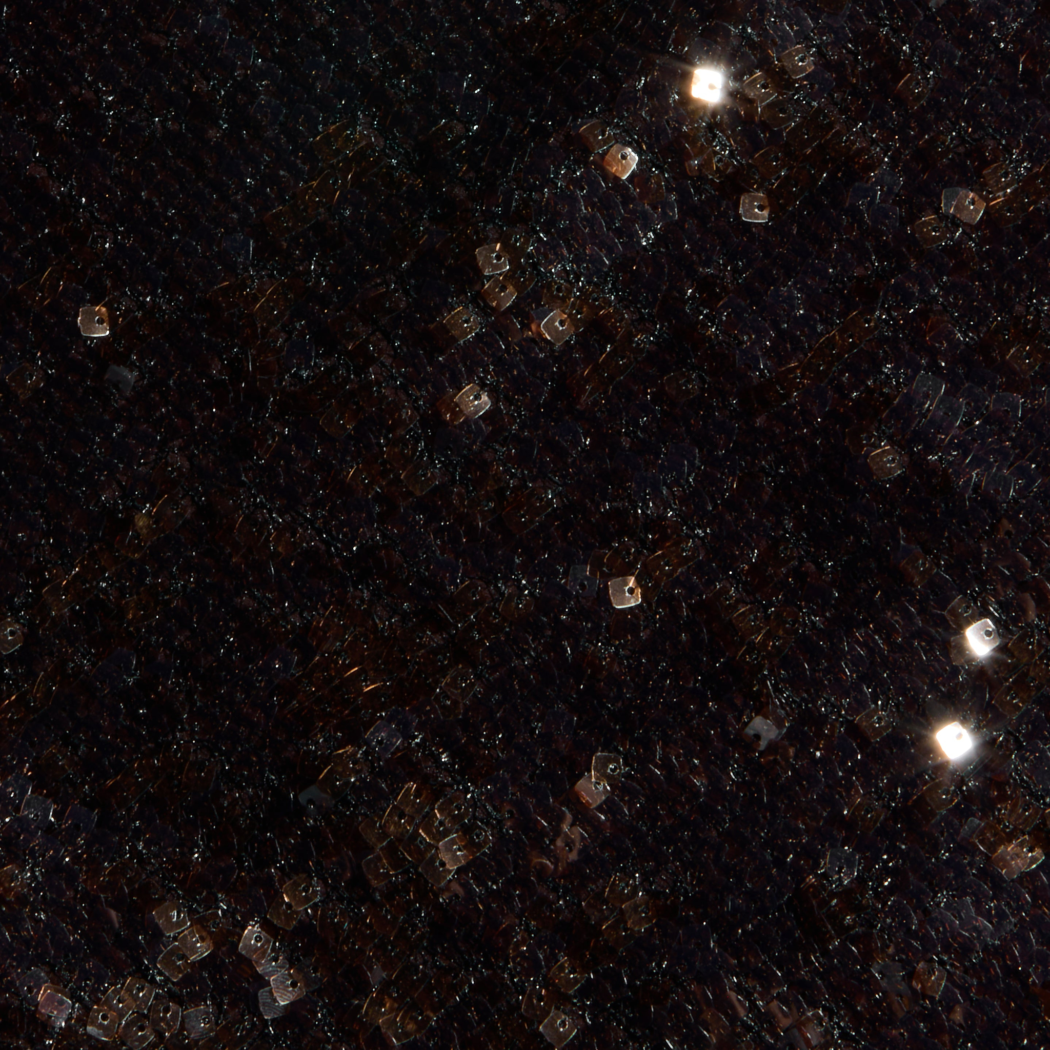 A dark, grid-patterned surface studded with glowing square white and orange lights, scattered like stars or pixels, conjures the dazzling effect of the Sayla Sequin Gown—an event-ready dress designed to shine at any occasion.
