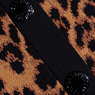 Close-up of the Osiris Jacquard Cardigan, featuring a brown and black leopard print in jacquard knit, a black textured vertical strip, and two round, shiny black buttons on the strip.