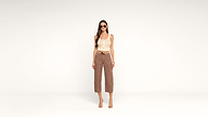 Woman wearing sunglasses, a beige sleeveless top, brown cropped pants, and heeled sandals stands confidently against a plain white background.