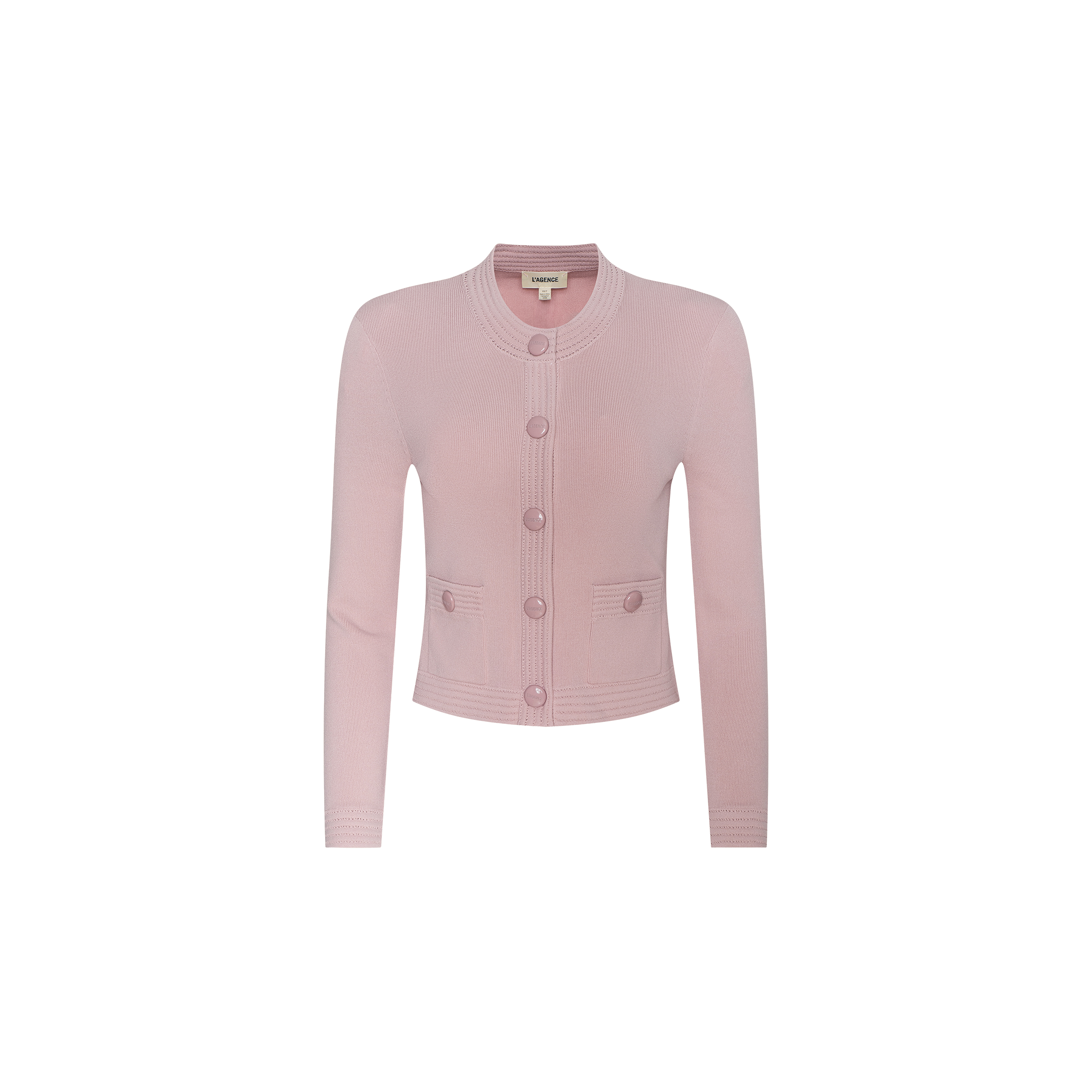 The Patsy Cropped Cardigan is a light pink, long-sleeve piece crafted in a delicate pointelle knit, featuring large front buttons, two front pockets, and a round neckline. It is displayed on a plain white background.