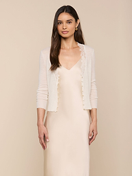 Wearing the Eluna Cardigan Top over a matching satin slip dress, a woman with long brown hair stands against a plain light background.