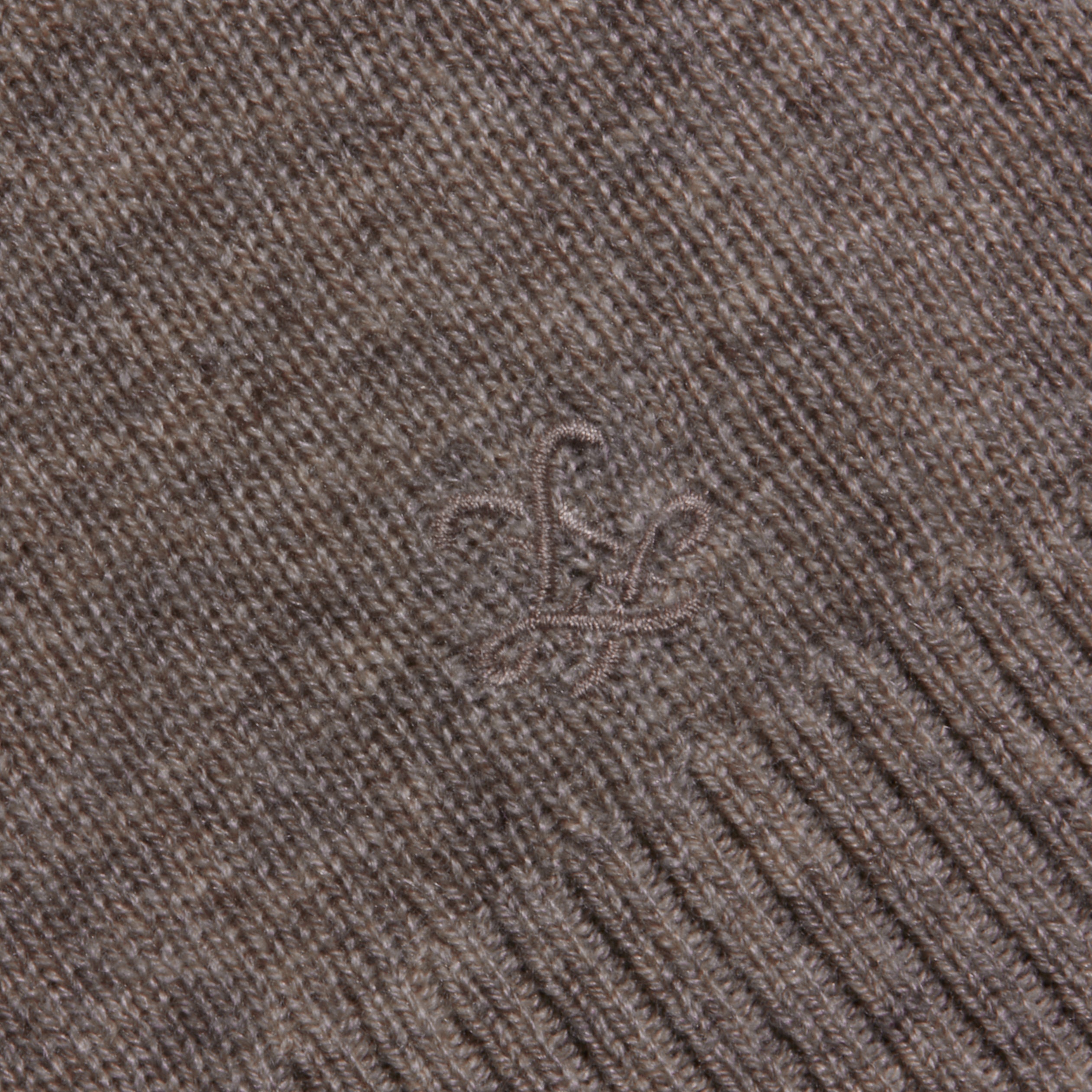 Close-up of the Malone Cashmere Cardigan, showcasing its brown knitted cashmere fabric with a subtle embroidered design and ribbed edging.