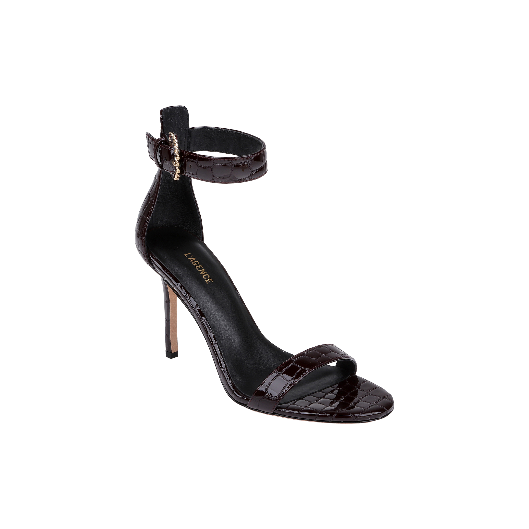 The Gisele Leather Sandal is a black, high-heeled ankle-strap sandal featuring a gold buckle, open toe, and crocodile embossed leather finish, displayed on a white background.