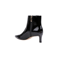 The Lilly Kitten-Heel Bootie, crafted from shiny black patent leather, features a pointed toe, a mid-height stiletto heel, and a convenient side zipper. It is displayed on a plain white background.