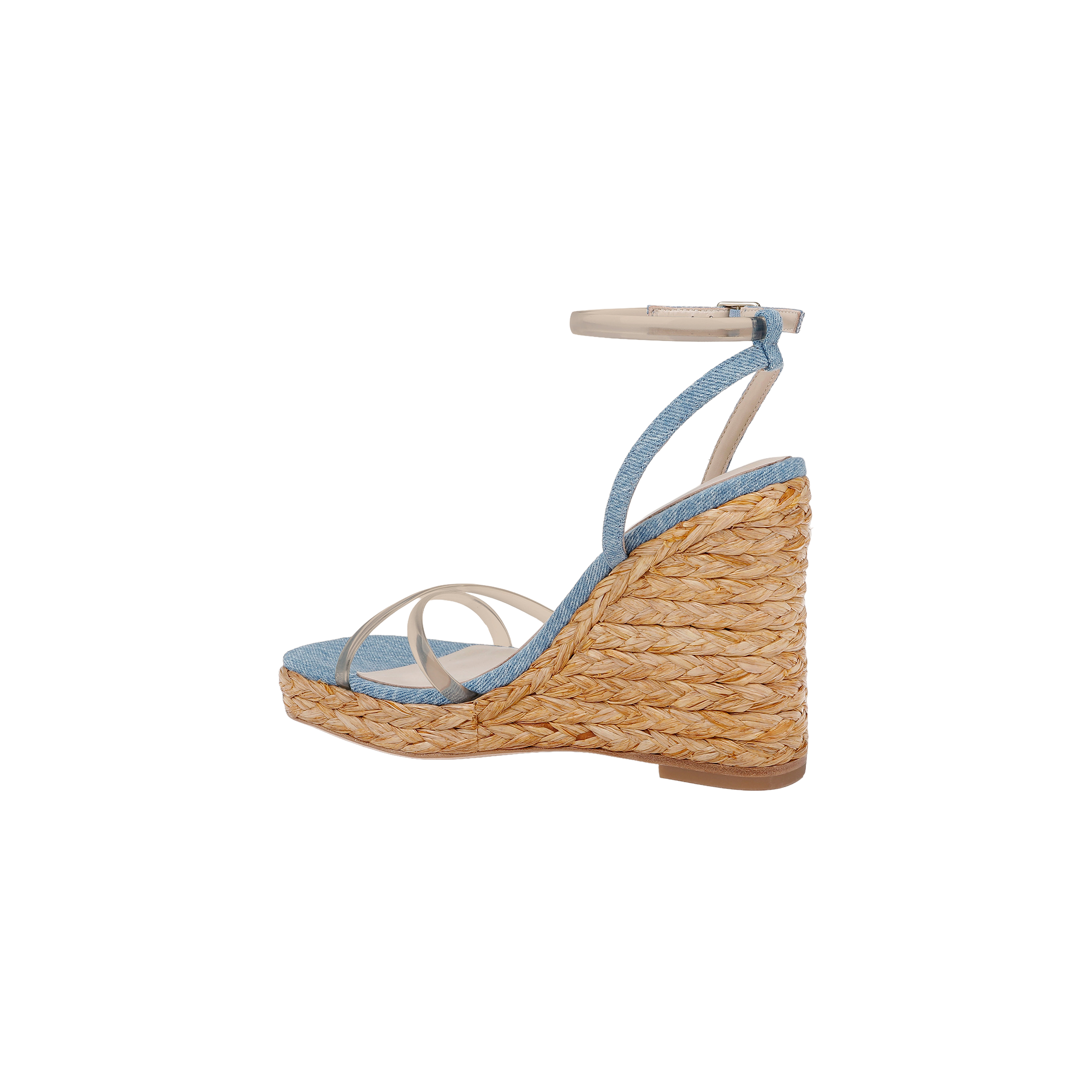 The Malone Wedge Espadrille is a bohemian espadrille wedge sandal featuring a braided straw sole, light blue fabric upper, thin white straps, and an ankle strap with a silver buckle. It includes a comfortable memory foam insole and is shown in profile against a white background.