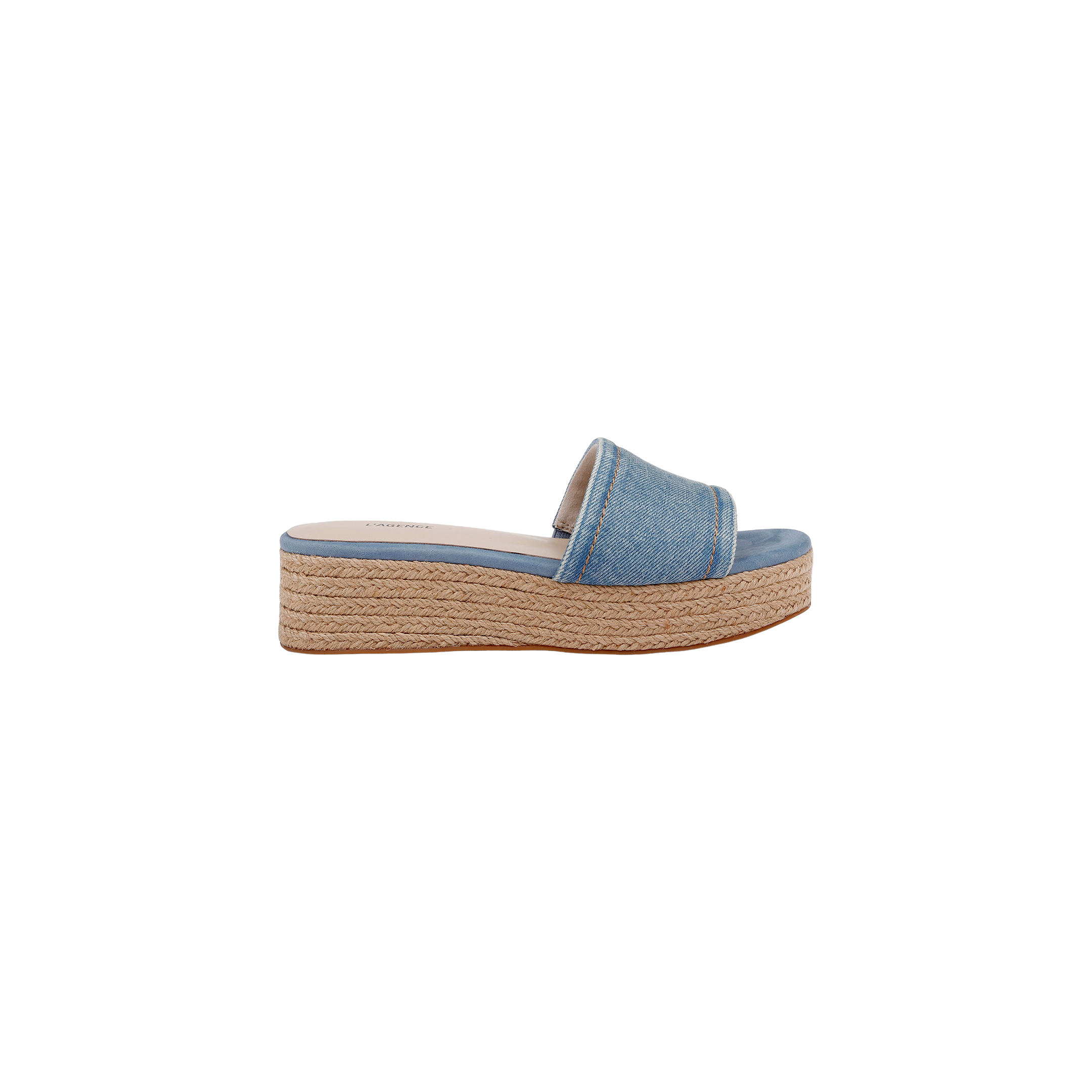 The Ramani Platform Espadrille features a blue denim upper with a wide strap and a platform sole wrapped in braided jute, styled in the classic platform espadrille design. The shoe is displayed in a side profile view against a white background.