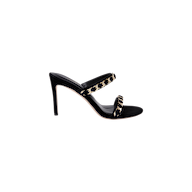 The Sarika Chain Sandal, a black suede high-heeled sandal featuring two gold chain-adorned straps, is shown in profile against a plain white background.