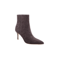 The Houston Bootie is a dark gray suede heeled bootie featuring a pointed toe and a thin high heel, photographed against a plain white background.