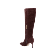 Introducing the Herald Boot: a single knee-high boot crafted from mahogany brown suede, featuring a pointed toe and a slim stiletto heel. The design is accented by a side zipper with a small gold-tone pull, all set against a plain white background.