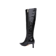 The Baxter Boot is a black knee-high patent leather boot featuring a pointed toe, mid-height heel, and gold side zipper, shown against a plain white background for a comfortable yet stylish look.