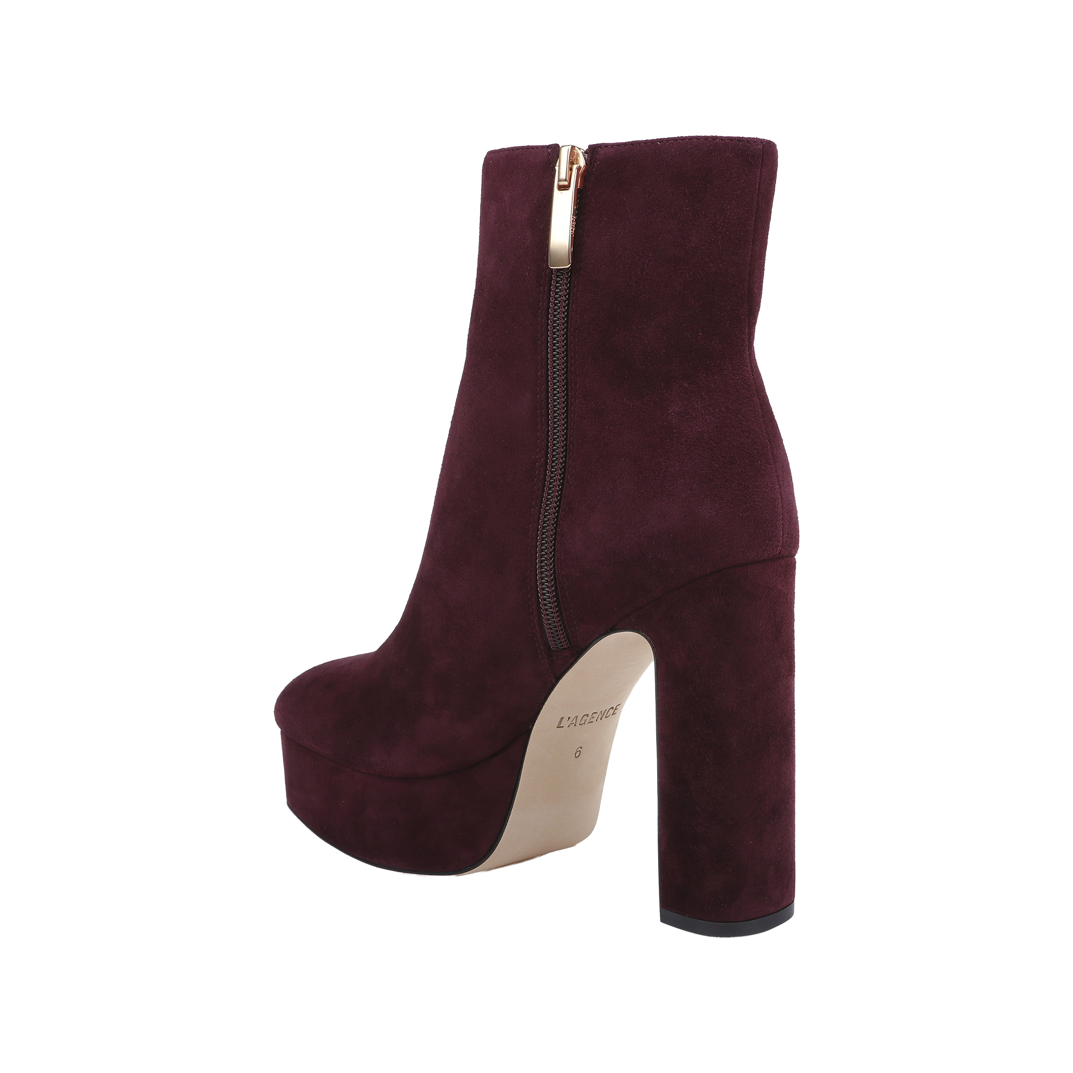 The Soho Bootie, shown on a white background, features burgundy suede, a platform sole, chunky block heel, gold zipper detail, and a light-colored sole.