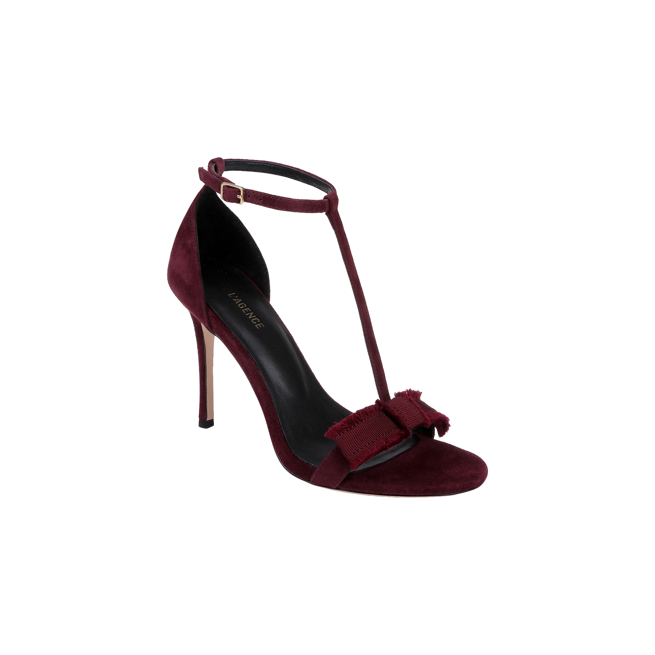 The Lerner Sandal features a burgundy suede upper in a T-strap design, complete with a stiletto heel, ankle buckle, and a decorative bow accenting the open toe.