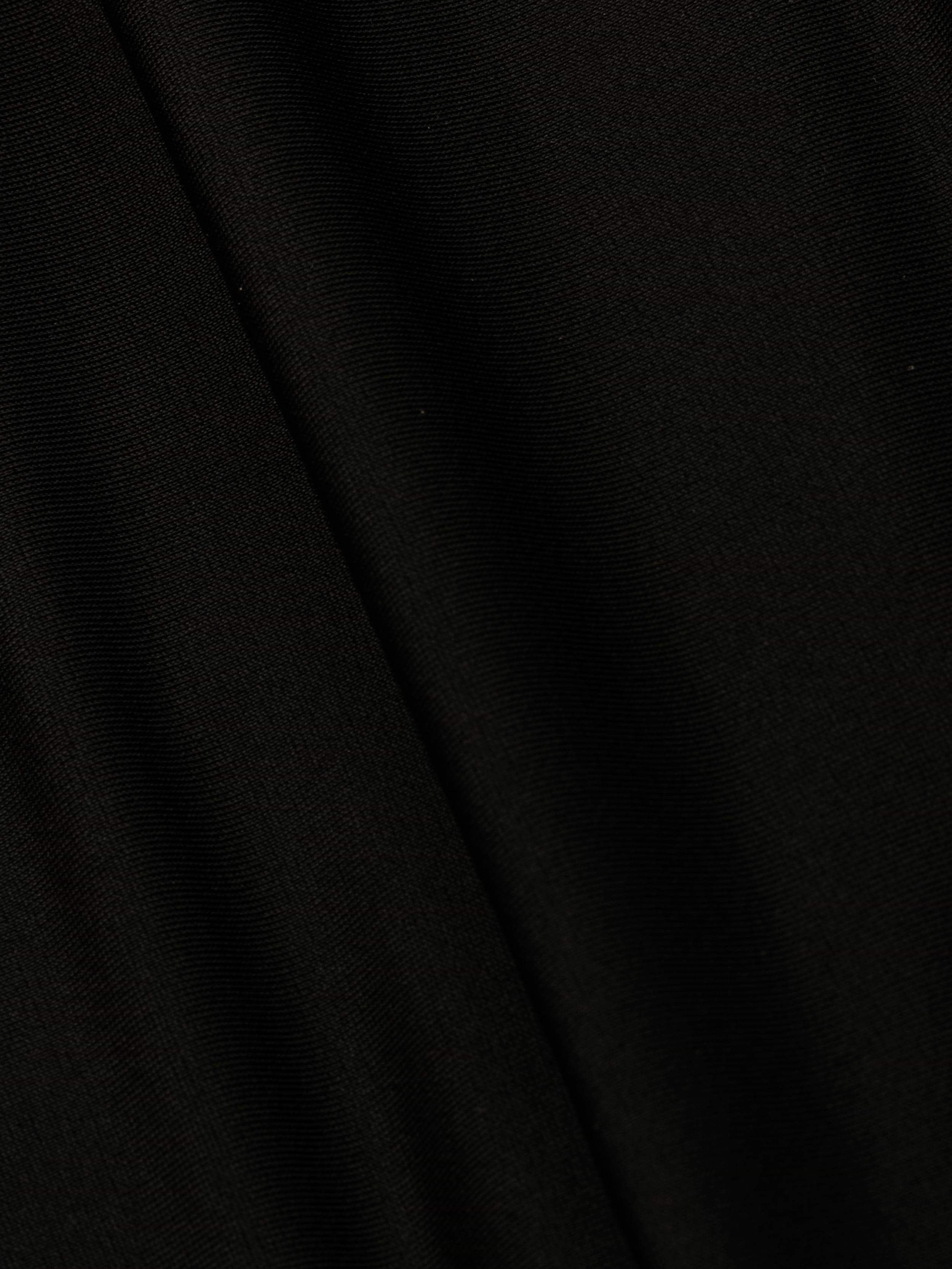 A close-up of the Emelia Bandeau One-Piece Swimsuit in black, highlighting its smooth texture, fine weave pattern, and four-way stretch nylon with a subtle diagonal fold in the fabric.