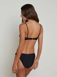 A woman with long brown hair is standing with her back to the camera, wearing the Krysta Bandeau Top against a plain light background.