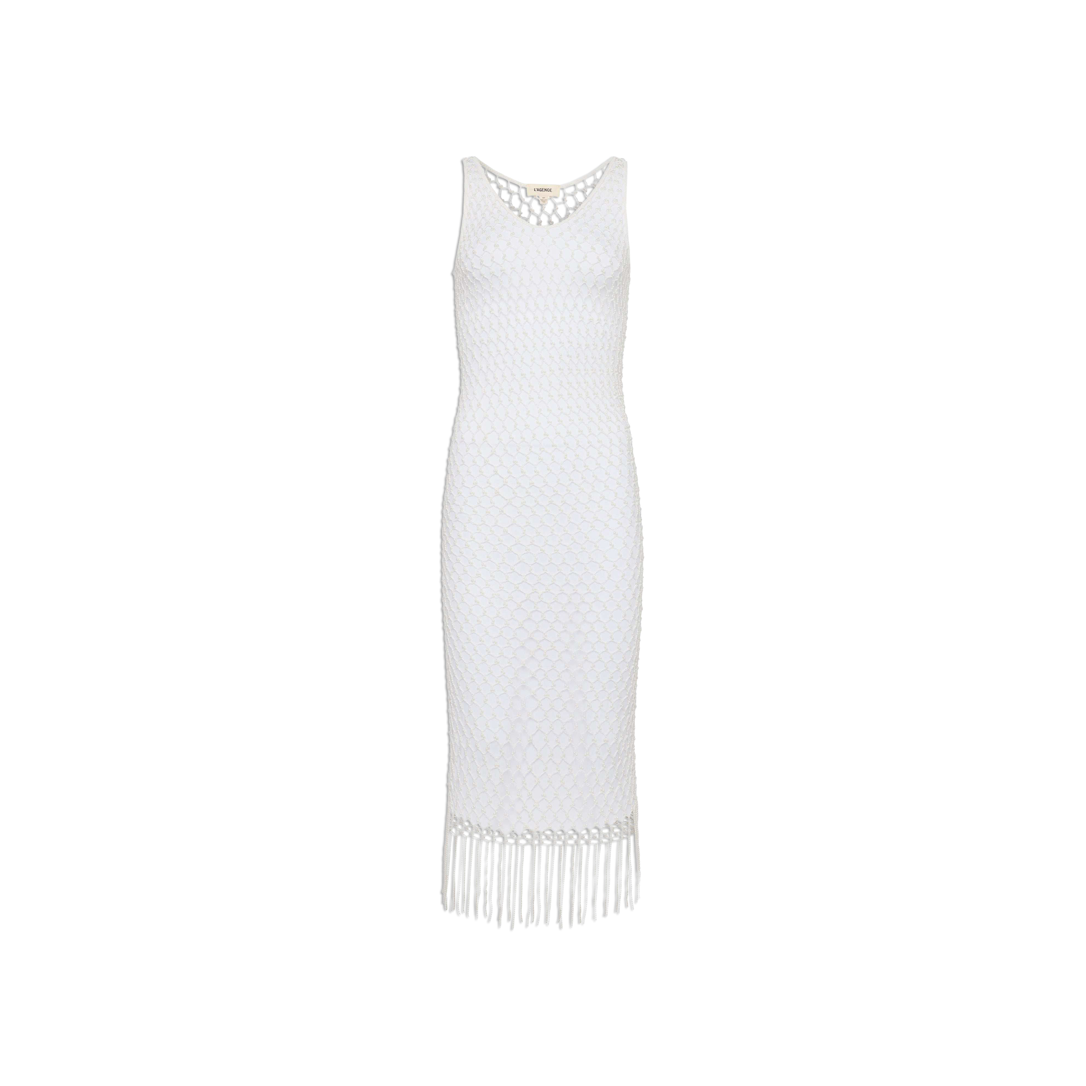 The Angela Crochet Cover-Up Dress is a sleeveless white dress with a fitted silhouette, showcasing a diamond-patterned crochet texture and a fringe hem. It features a scoop neckline and falls to mid-calf length.