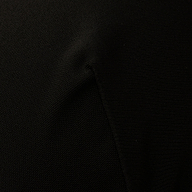 Close-up of the Adrienne Bikini Top in black, showcasing visible fabric texture and seams, with subtle folds and shadows reminiscent of Trapunto stitching.