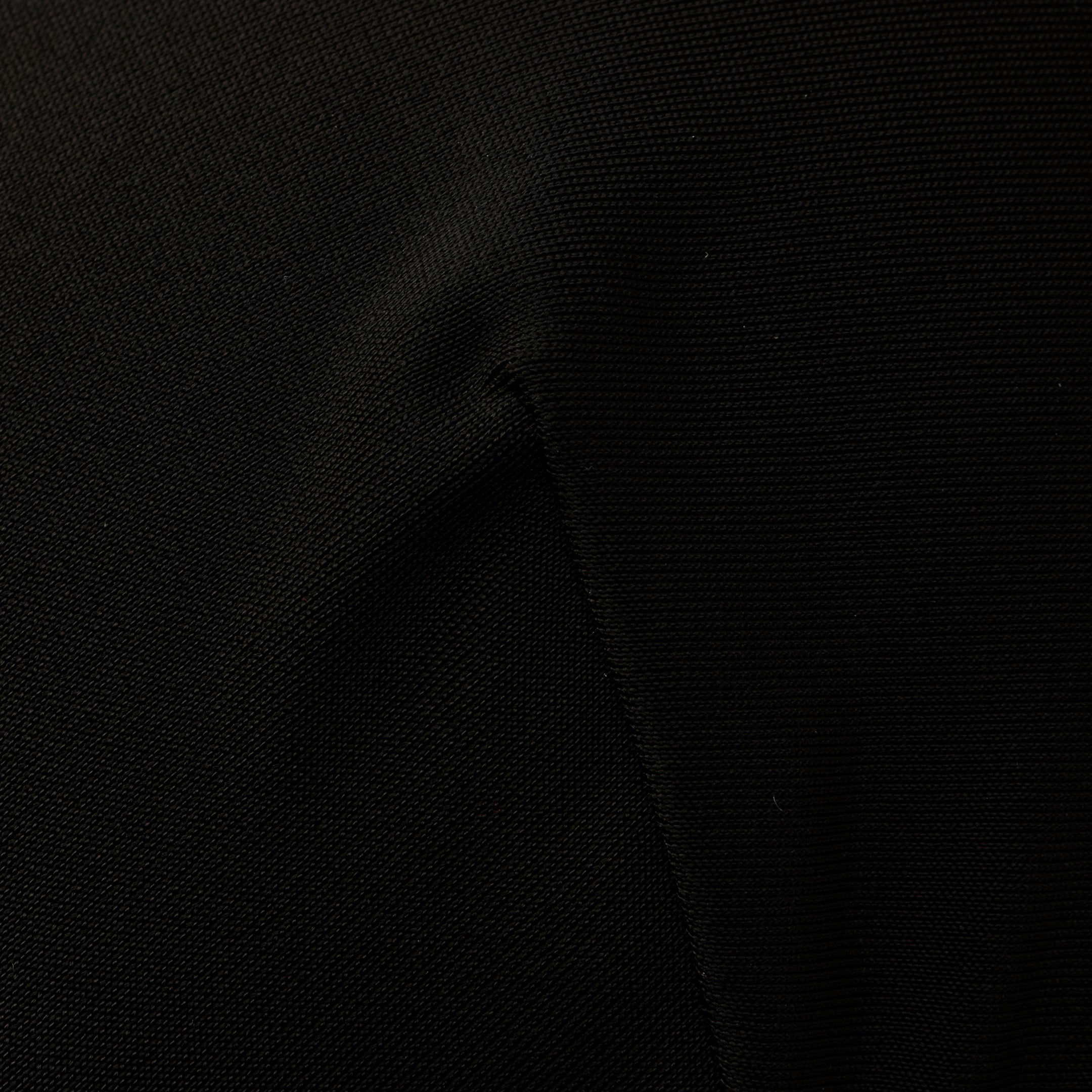 Close-up of the Adrienne Bikini Top in black, showcasing visible fabric texture and seams, with subtle folds and shadows reminiscent of Trapunto stitching.