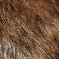 A detailed close-up of the Hazel Faux Fur Stole showcases its natural-looking brown, black, and tan fibers with a glossy finish. The dense, layered hairs feature varied colors and lengths, making it an ideal plush statement accessory for glamorous style.