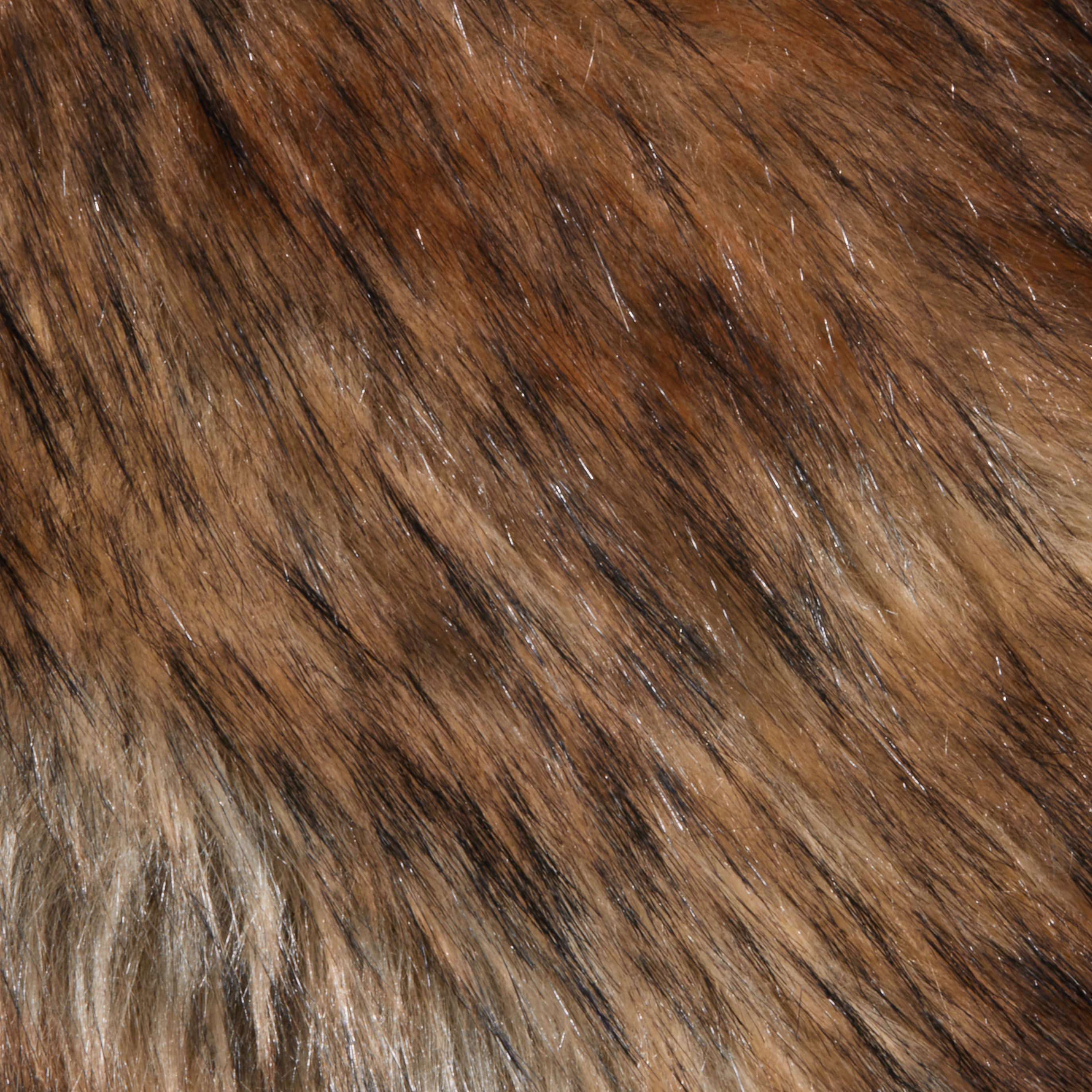 A detailed close-up of the Hazel Faux Fur Stole showcases its natural-looking brown, black, and tan fibers with a glossy finish. The dense, layered hairs feature varied colors and lengths, making it an ideal plush statement accessory for glamorous style.