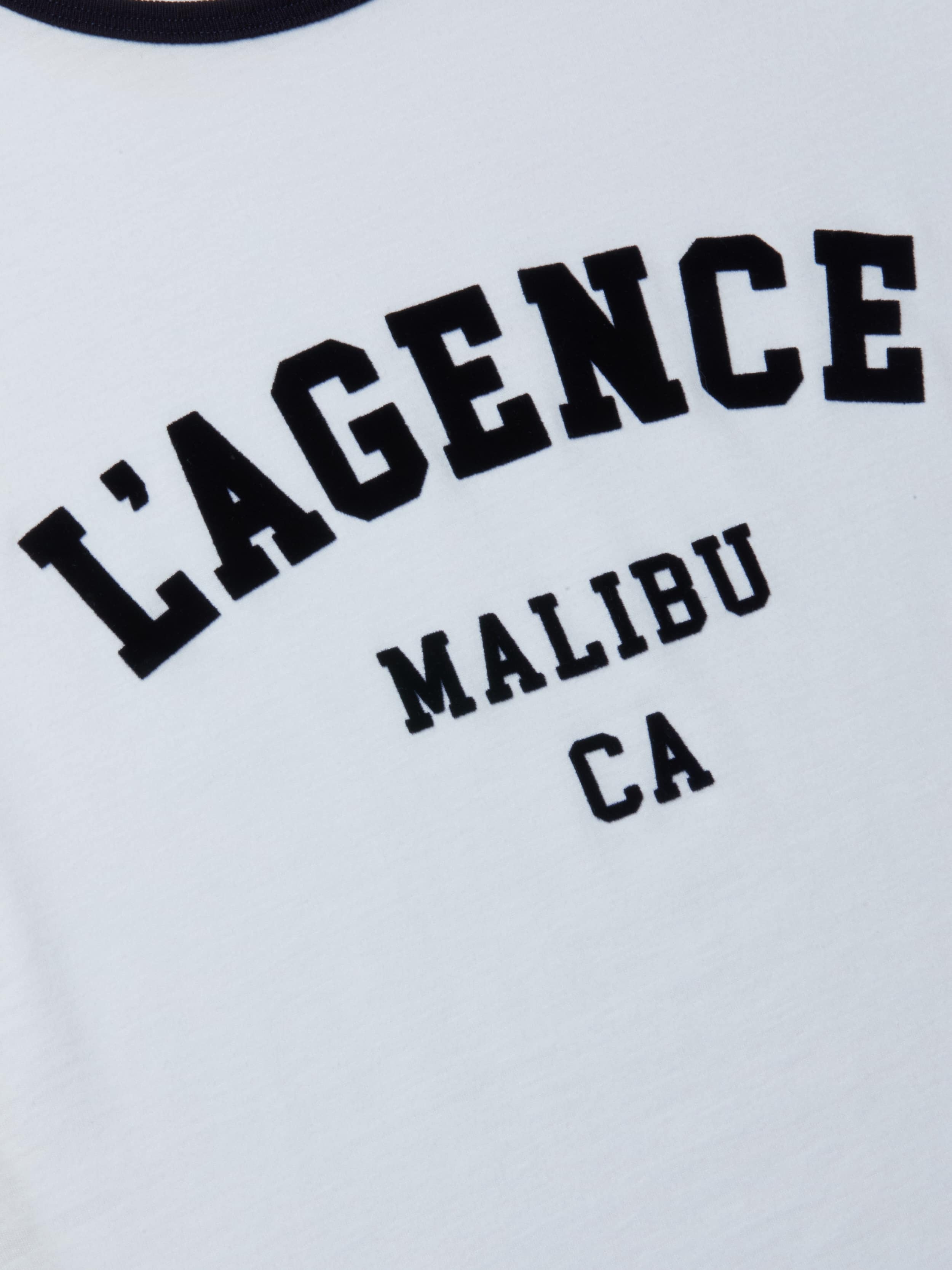 Tommie Crewneck Tee: A white ringer tee featuring bold, collegiate-style black text that reads “LAGENCE MALIBU CA,” crafted from soft Supima cotton and detailed with the signature L’AGENCE logo.