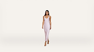 A woman wearing a light pink, sleeveless, ankle-length dress and beige heels walks forward against a plain white background.