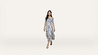 A woman in an off-shoulder, blue floral dress and sandals walks forward against a plain white background.