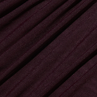 Close-up of ribbed maroon fabric with diagonal folds, highlighting the texture and weave of the Anya Shirred Dress in merlot red.