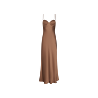 The Sayla Silk Gown, featuring a brown satin finish, thin spaghetti straps, a fitted bodice, and a flared skirt that radiates vintage glamour, is displayed against a plain white background.