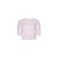 The Guinevere Cropped Pullover is a light pink, short-sleeve crewneck sweater crafted from soft, textured fabric. Featuring a relaxed fit and a small tag near the bottom hem, this pullover is displayed on a plain white background.