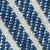Close-up of a blue and white striped textile pattern, showing diagonal lines with a raised, textured surface. The fabric appears woven, with alternating dark blue and light threads.