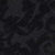 Dark, textured surface with an abstract, camouflage-like pattern in shades of black and deep gray.