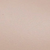A close-up image of a smooth, light beige surface, possibly skin or a similar material, with no distinct features or patterns visible.