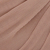 Close-up of a textured surface with a repeating honeycomb or hexagonal pattern in shades of beige and light brown. The material appears woven or embossed, giving it a three-dimensional look.