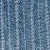 Close-up of blue denim fabric showing visible vertical white stitching and textured weave pattern.