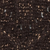 Close-up image of dark brown soil with small pebbles and bits of organic material scattered throughout. The texture appears rough and uneven, suggesting fertile ground.