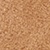 Close-up of a textured corkboard surface, showing its natural brown color and rough, grainy pattern.